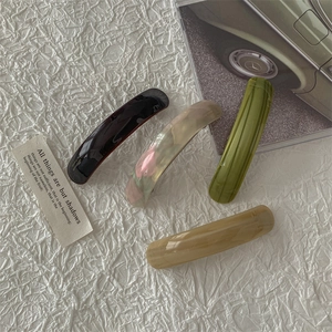 Set of four premium acetate hair clips in burgundy, pearl white, green, and beige
