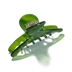Elegant emerald green acetate claw clip for hair featuring a durable gold metal spring