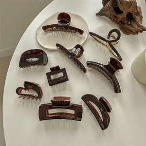 Chocolate brown acetate hair claw set in diverse geometric shapes with golden finish