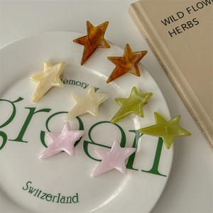 Set of colorful acetate star hair clips in marble patterns including tortoise and cream colors