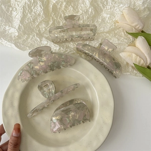 Elegant iridescent acetate hair claw clips with pearlescent shell texture for women styling