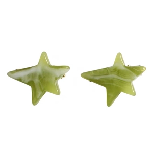 Pair of green marble acetate star hair clips with elegant resin texture on white background