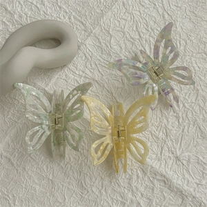 Three hollow butterfly hair claws in marble acetate finish on white background