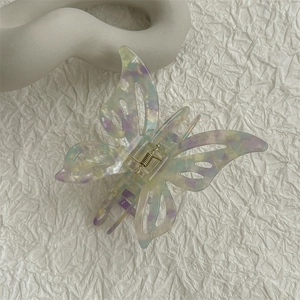 Detailed macro view of the marble patterned acetic acid butterfly hair claw clip