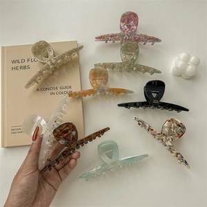 Elegant large acetate claw clips in marble and tortoiseshell patterns for women