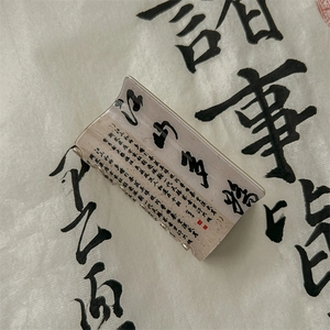 Detailed view of ink-wash calligraphy hair claw clip with traditional red seal pattern