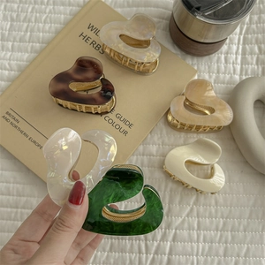Irregular acetate heart hair claw clip with marble texture in multiple colors