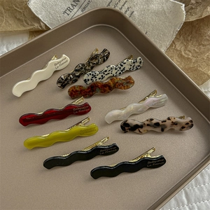 Set of ten vintage wavy acetate hair clips in assorted marble and tortoiseshell patterns