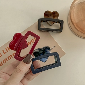 Minimalist square acetate hair claws with heart design in red, black, and blue marble