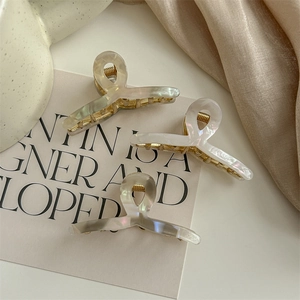 Three-piece set of elegant pearlescent hair claws with gold-tone metal springs