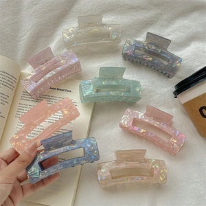 Elegant iridescent rectangle hair claws in various colors with a sleek pearlescent finish