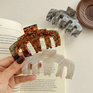 Large acetate hair claws in tortoiseshell and marble patterns for elegant hair styling