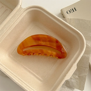 Detail of amber tortoise shell acetic acid hair claw with France Handmade lettering