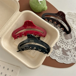 French style acetate hair claw set in red, black and tortoiseshell with gold lettering