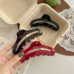 French style hollow acetate hair claw clips in black, brown, and red with gold lettering