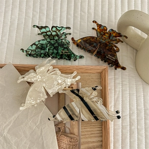 Elegant vintage butterfly hair claw clips in a 4-piece set with multiple acetate patterns