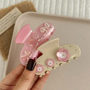 Elegant floral acetate hair claws with rhinestones in pink and cream white colors