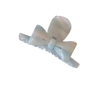 Elegant floral bow hair claw clip made of pearlescent acetate for a stylish French updo style