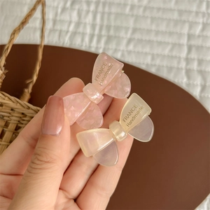 Cute jelly colored acetate bow hair clips in pink and beige colors for sweet women styling