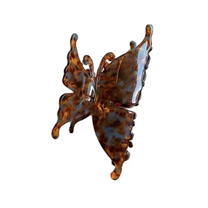 Elegant butterfly hair claw clip with vintage tortoiseshell pattern on white background