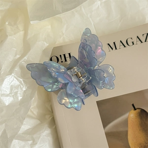Detail showing the iridescent butterfly hair claw clip with its metal spring mechanism