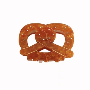 Retro amber acetate hair claw clip with pretzel twist design and glossy finish