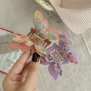 Elegant iridescent acetate butterfly hair claw clips for women with marble texture finish