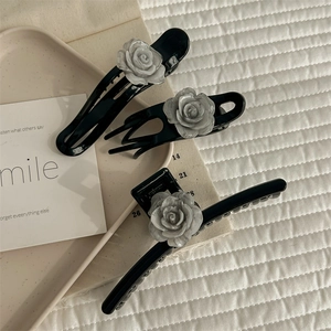Three-piece black camellia hair claw clip set with elegant marble texture flower detail