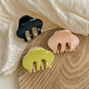 Three-piece set of glossy acetate hair claws in black, pink, and green for elegant styling