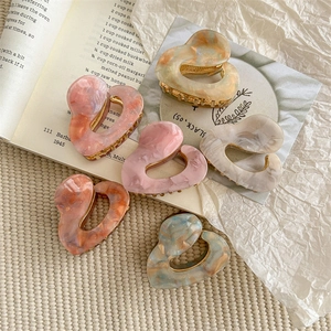 Set of 6 French acetate heart hair claws in mixed marble colors on aesthetic backdrop