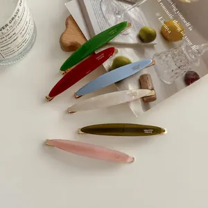 Elegant French style leaf-shaped acetate hair clips in six colors on aesthetic background