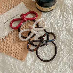 Elegant bow hair ties set in red, marble white and tortoise shell finish for ponytails