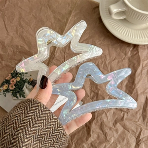Iridescent star-shaped hair claw clips set in shimmering white and blue acrylic finish