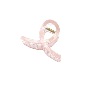 Minimalist pink marble acetate hair claw clip with cross-over design on white background
