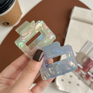 Iridescent square hair claw clips in light green and blue with a pearlescent finish
