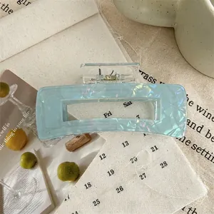 Detail shot of large square acrylic hair claw clip in pearlescent light blue color
