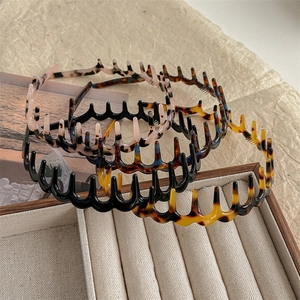 Set of 4 wave comb headbands in tortoiseshell, black, and marble pink colors