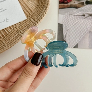Cute acetate pumpkin hair claws set in translucent deep cyan and colorful marble finish