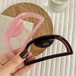 Minimalist semi-circle hair claw clips in jelly pink and caramel brown finishes