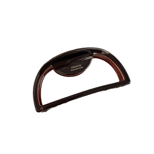 Elegant tortoiseshell claw clip in chocolate brown with gold handmade logo lettering