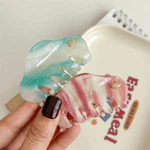 Elegant marbled acetate hair claw clips in mint green and pink gradients with gold logo