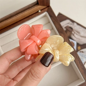 Pink and beige acetate bow mini hair claws for elegant high ponytail hairstyles