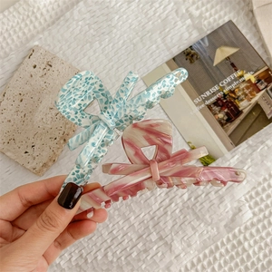 Elegant large butterfly hair claw clips with blue floral and pink marble patterns