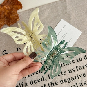 Elegant butterfly hair claw clips in cream and green marble finish for chic hairstyling