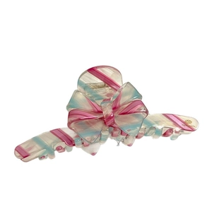 Large acetate bow hair claw clip with pink and blue twill pattern and gold label