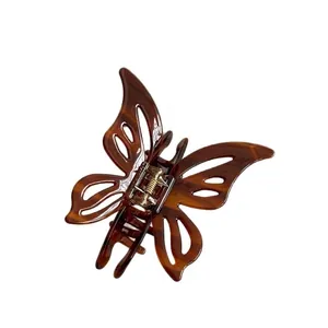 Elegant butterfly claw clip in tortoise shell pattern with minimalist hollow design