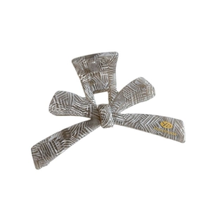 Pink marble style butterfly hair claw clip with gold logo detail for women