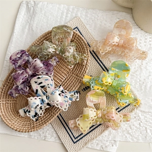 Elegant acetate bow hair claws with vintage lace edges and marble texture in various colors