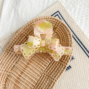 Detailed view of handmade marble acetate bow hair claw clip in sweet vintage style