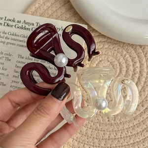Elegant medium hair claw clips in wine red and iridescent finish with large pearl accent